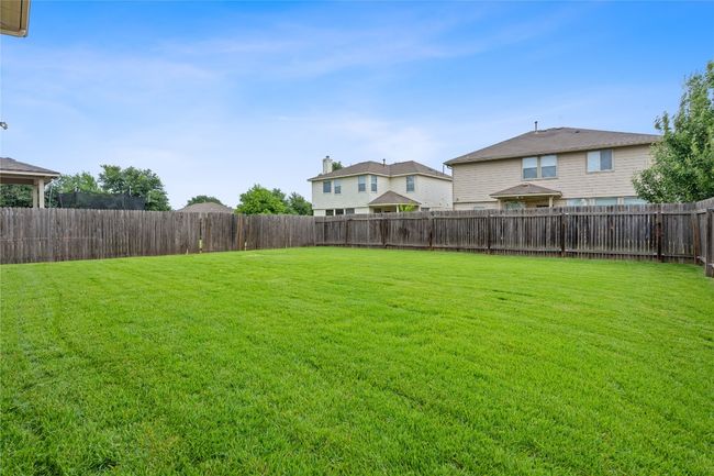 View of fenced backyard | Image 38