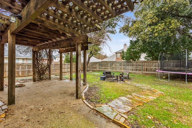 Fenced backyard with a pergola - Wisteria vines covering | Image 31