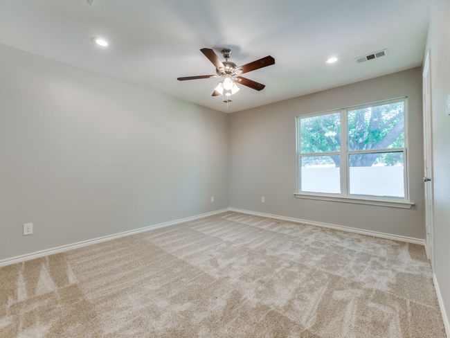 Carpeted spare room featuring a ceiling fan, baseboards, and recessed lighting | Image 13