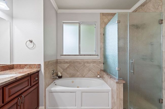 Full bath featuring vanity, crown molding, and a stall shower | Image 26