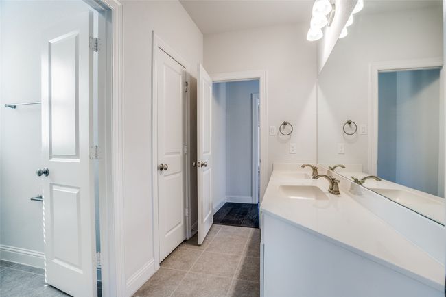 Bathroom with double vanity and tile patterned floors | Image 20