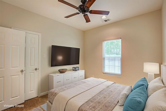 Bedroom with light carpet and a ceiling fan | Image 25