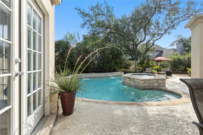 View of swimming pool with a patio and a pool with connected hot tub | Image 25