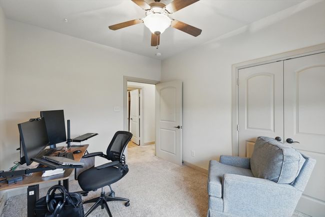 Home office with light colored carpet and ceiling fan | Image 26