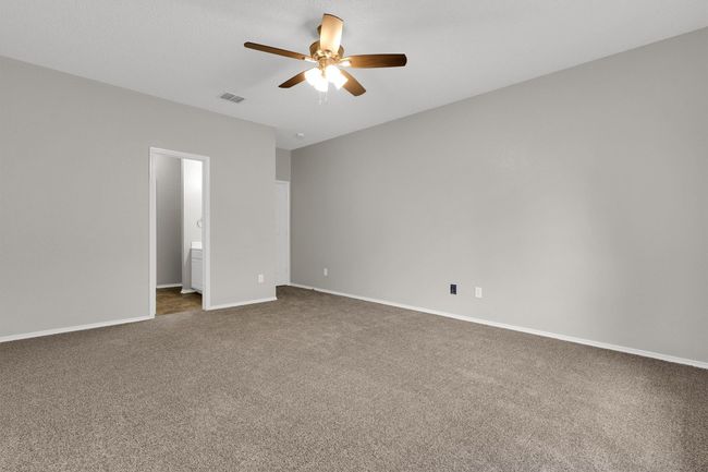 Spare room with ceiling fan, dark carpet, and baseboards | Image 19