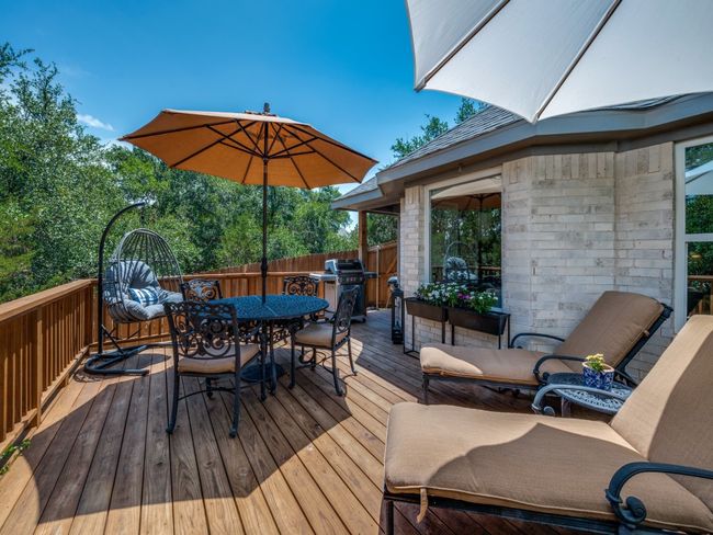 Deck with outdoor dining space and a grill | Image 25