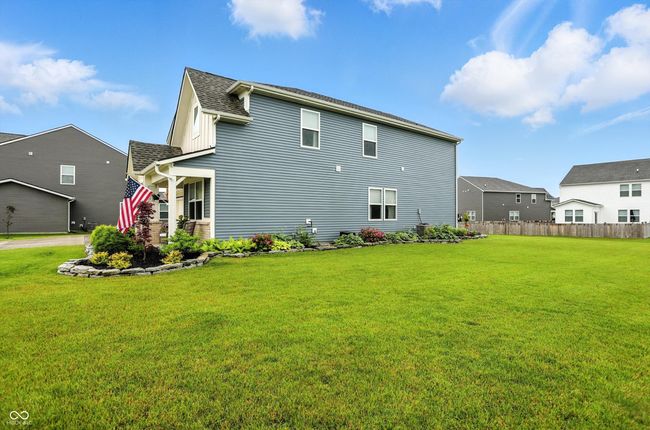 rear view of property featuring a shingled roof | Image 43