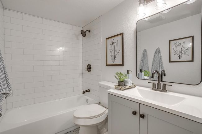Bathroom featuring vanity, shower combination, and a textured wall | Image 20