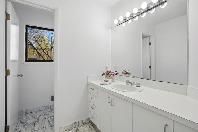 Powder features over-sized vanity and water closet. | Image 12