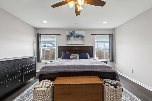 Bedroom with baseboards, dark wood finished floors, a ceiling fan, and recessed lighting | Image 18