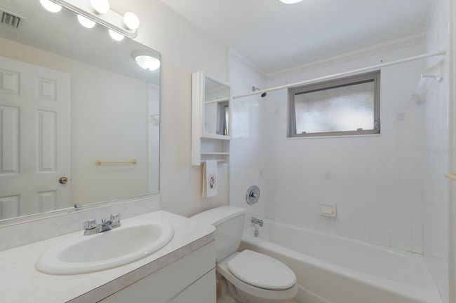 The guest bath has a convenient layout and nice window for those seasonal breezes and cross ventilation. | Image 15
