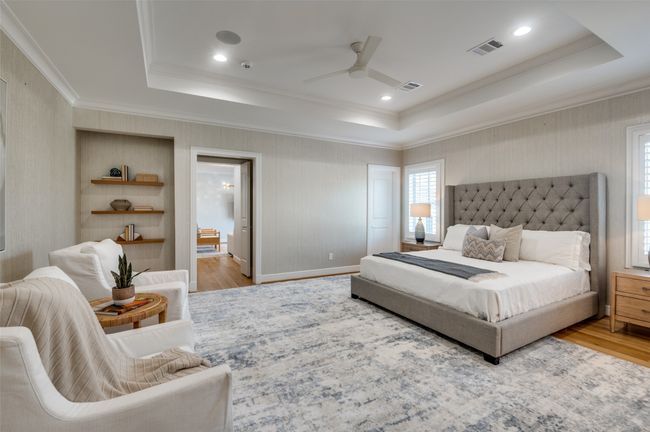 Bedroom with light wood-type flooring, a raised ceiling, and visible vents | Image 14