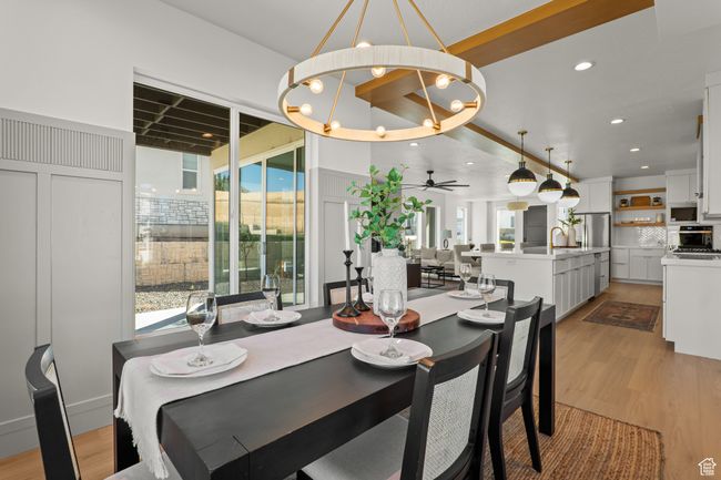 Dining space with a chandelier, light wood-style flooring, ceiling fan, and recessed lighting | Image 27