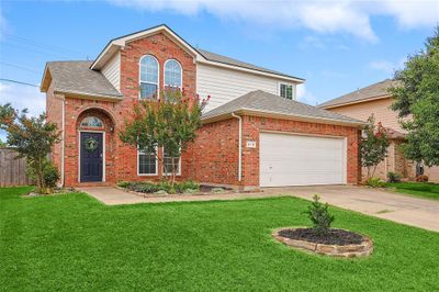 Front of property with a garage and a front lawn | Image 1