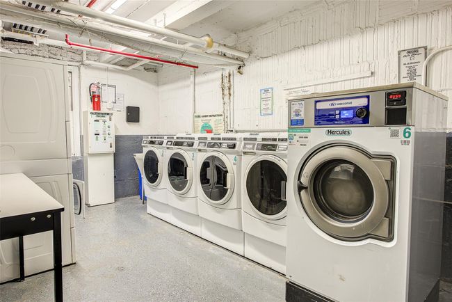 Shared laundry area with stacked washer and clothes dryer and independent washer and dryer | Image 14