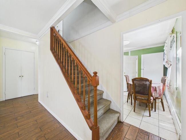 Staircase featuring hardwood / wood-style flooring and crown molding | Image 11