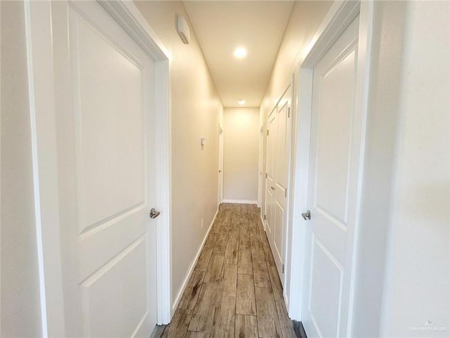 Hallway with wood finished floors, baseboards, and recessed lighting | Image 15