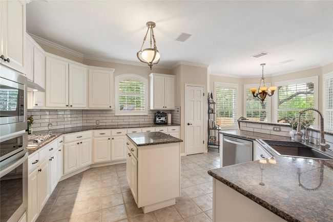 Enjoy the flow of this open-concept kitchen with a smart and functional layout. | Image 14