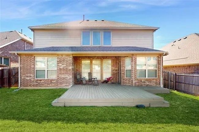 Back of property featuring a fenced backyard, brick siding, and a wooden deck | Image 20