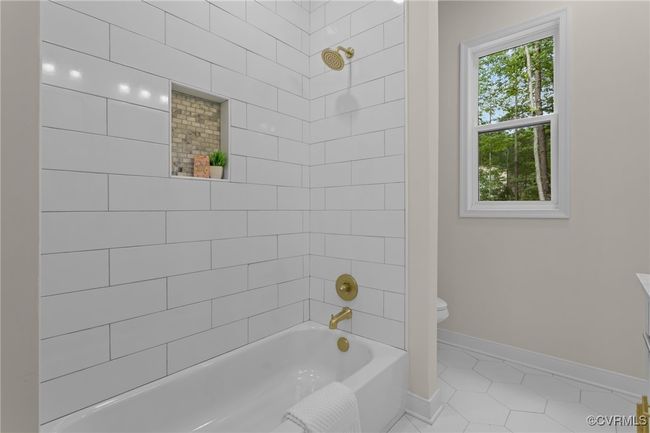 Full bath with tile patterned floors and bathtub / shower combination | Image 20