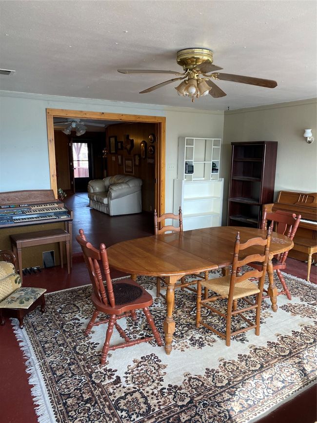 Dining area with crown molding, ceiling fan, and hardwood / wood-style flooring | Image 9
