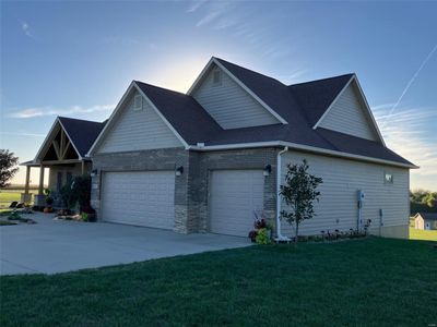 Property exterior at dusk with a yard and a garage | Image 3