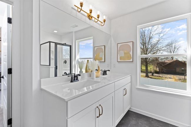 Bathroom featuring a shower with shower door and vanity | Image 24