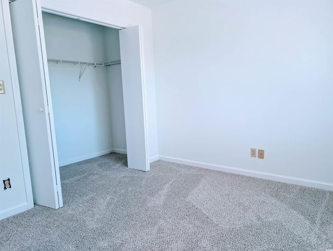 Unfurnished bedroom featuring carpet flooring and a closet | Image 9