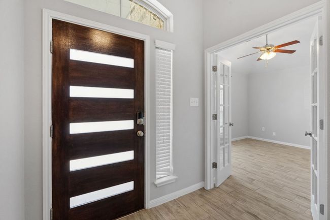 Foyer entrance with modern lited-wood front door | Image 22