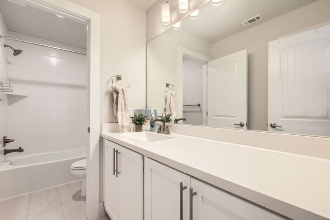 Full bathroom with vanity, tile patterned floors, and bathtub / shower combination | Image 23