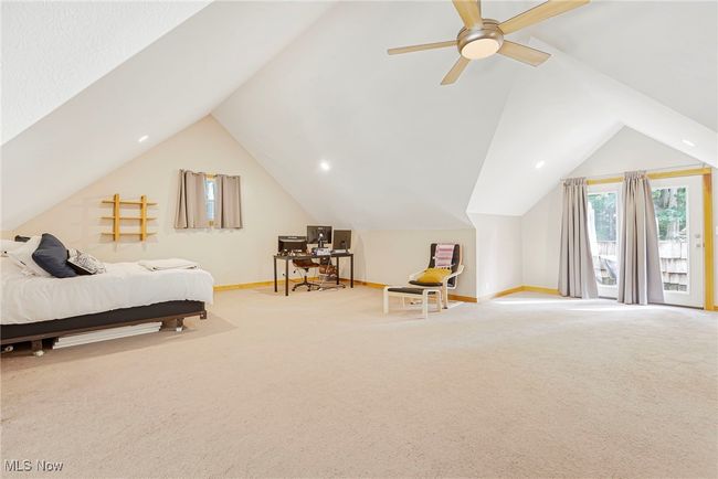 Bedroom featuring an office area, carpet, and lofted ceiling | Image 29