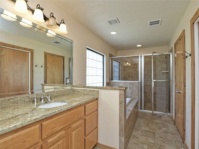 Granite and under-mount sink + a large soaking tub and over-sized walk-in shower are Primary Bath features. | Image 15