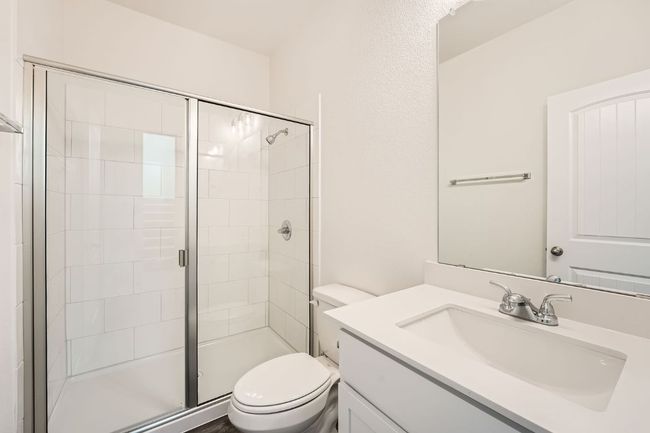 Full bathroom with vanity, a shower stall, and toilet | Image 13