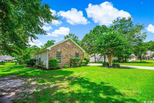 View of property exterior with brick siding and a lawn | Image 37