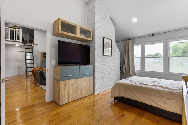 Exposed fireplace brick is a beautiful feature of this room. | Image 26
