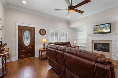 Built in bookcases surround the fireplace | Image 2