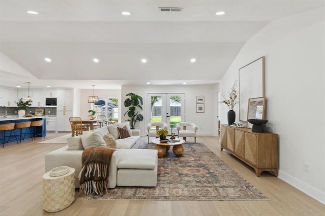 This spacious living area is enhanced by the cathedral ceilings and wide-plank white oak engineered hardwood floors. | Image 4
