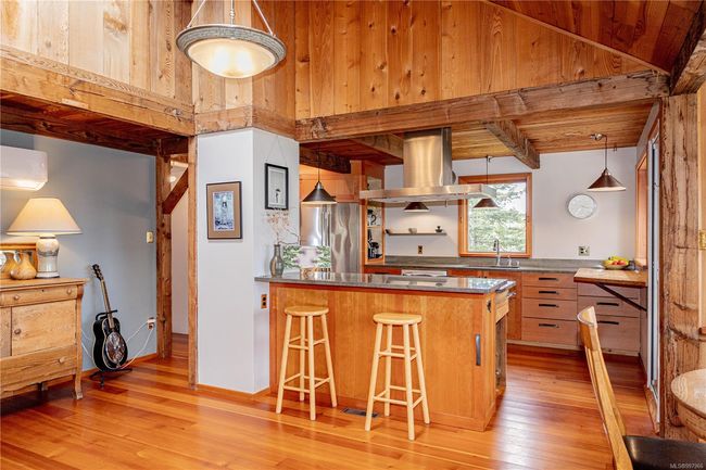 Kitchen with eat up bar and gas stove | Image 23