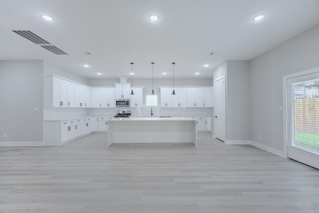 Formal dining room with elegant finishes and room for large gatherings | Image 12