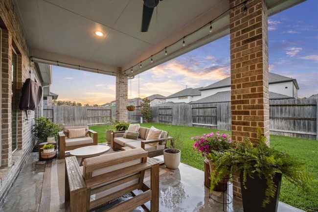 Enjoy your own private backyard sanctuary, complete with a privacy fence and a generous covered patio, ideal for unwinding in the shade and making the most of quiet Texas evenings. | Image 28