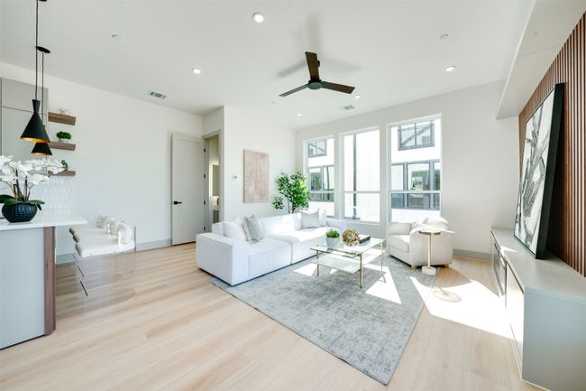 Living room with light hardwood / wood-style flooring and ceiling fan | Image 5
