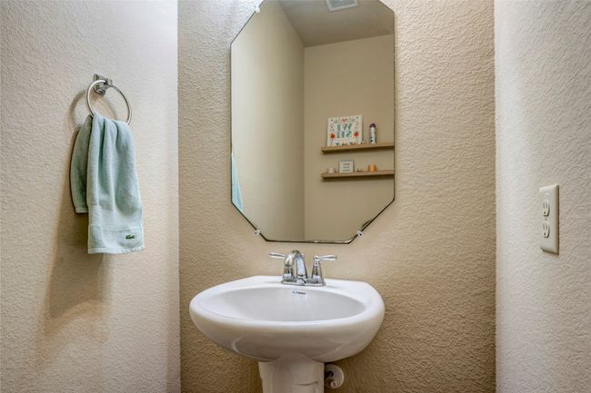 Bathroom featuring a sink and a textured wall | Image 29