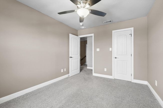 Unfurnished bedroom featuring carpet, baseboards, and a ceiling fan | Image 29