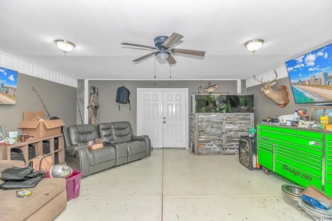 Living room with concrete floors and a ceiling fan | Image 20