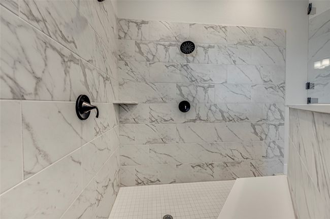 Bathroom featuring a tile shower | Image 14