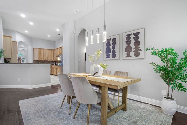 Dining space with arched walkways, wood finished floors, baseboards, and recessed lighting | Image 7