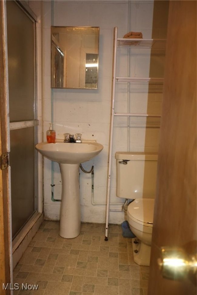 Bathroom with a stall shower and toilet | Image 13