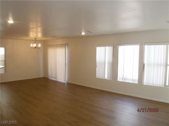 Dining room area with chandelier, baseboards, waterproof SPC wood finished floors, and a healthy amount of sunlight | Image 5