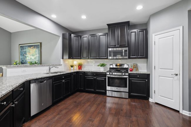 The ample granite countertops make kitchen prep a breeze. The SS appliances and staggered cabinets give this kitchen an elegance to be envied. Top that off with a walk in pantry and you have yourself a chef's delight! | Image 9