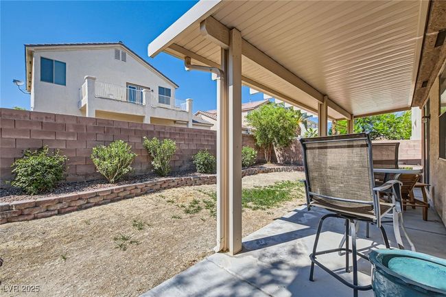 Fenced backyard with a patio and outdoor dining area | Image 40